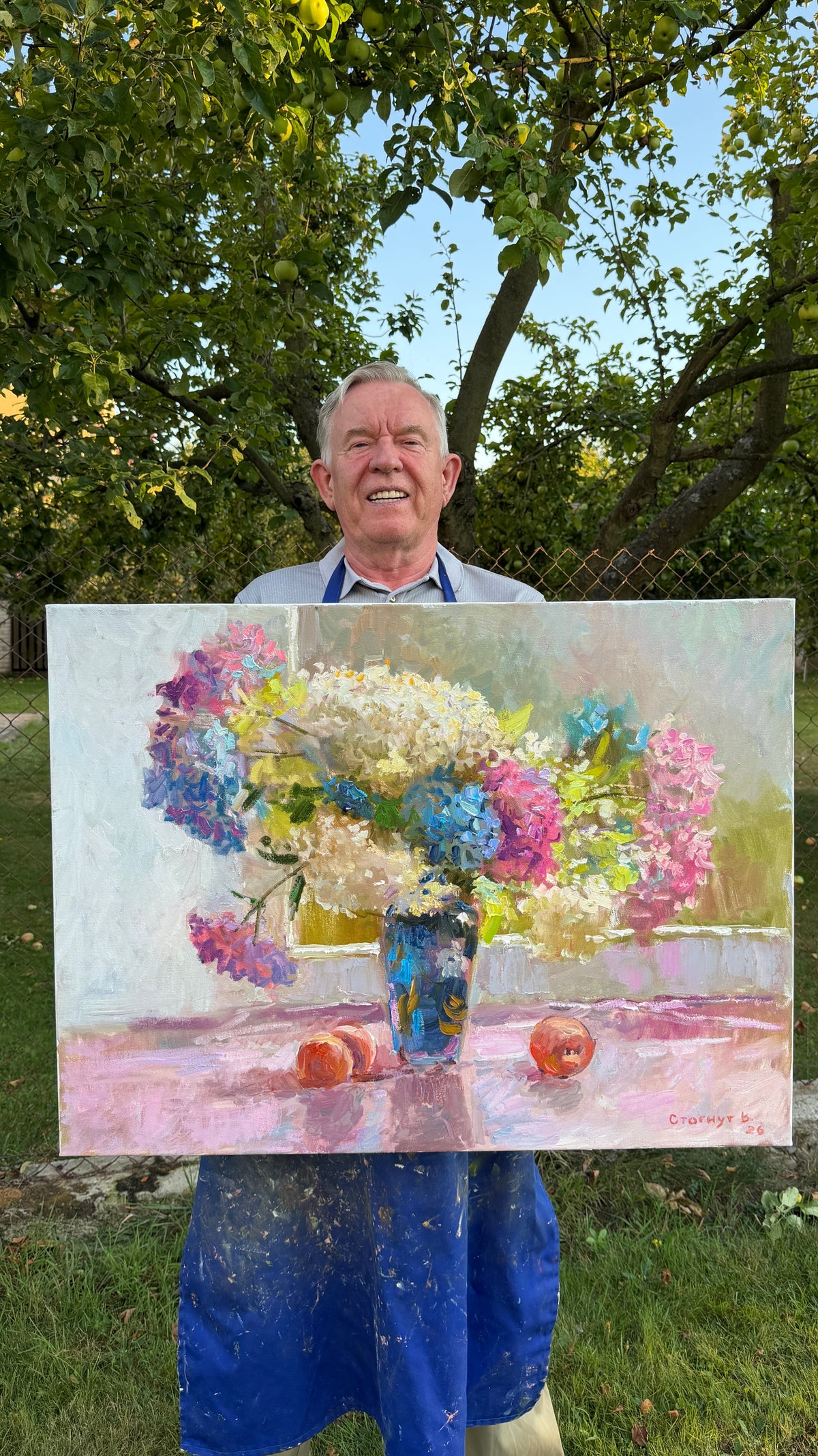 Artist Viktor Stognut with the painting “Summer Garden”