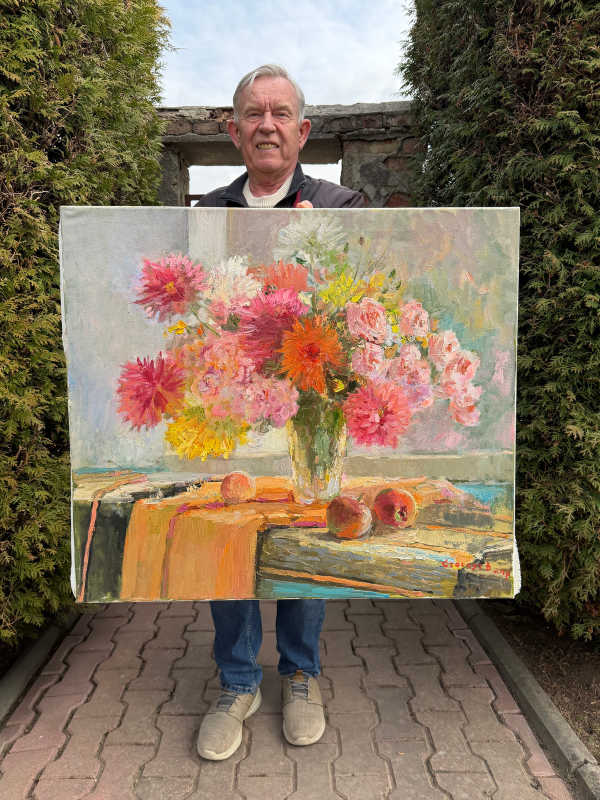 Artist Viktor Stognut with the painting “Summer in Full Bloom”